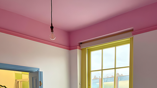 photo of a spare bedroom decorated in pink, yellow and blue