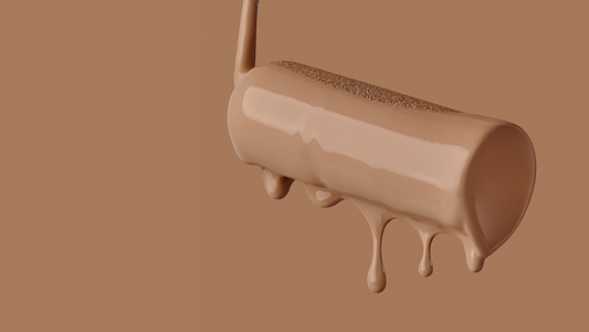 close-up of a paint-drenched paint roller with paint drips coming down from it in a warm brown colour photographed on a warm brown background