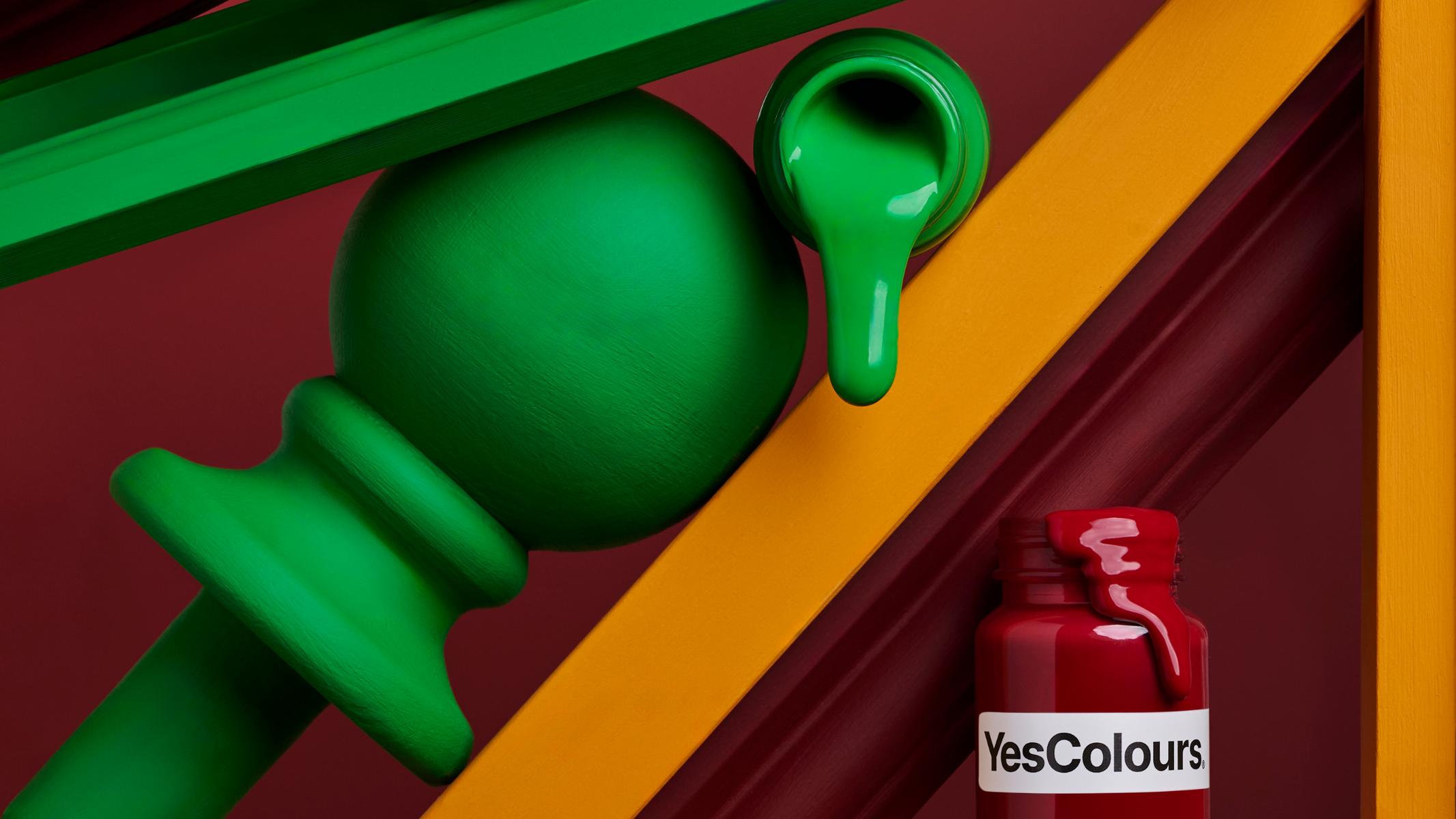 a vertically arranged collection of paint sample jars and painting accessories and tools, photographed on a bold dark red background