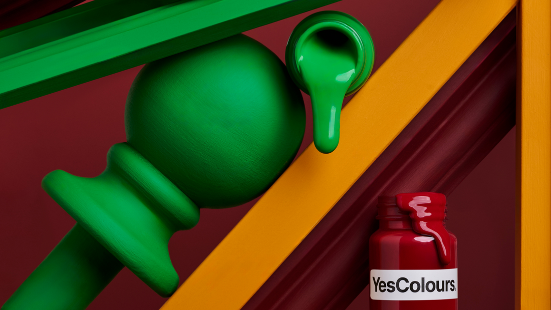 a vertically arranged collection of paint sample jars and painting accessories and tools, photographed on a bold dark red background
