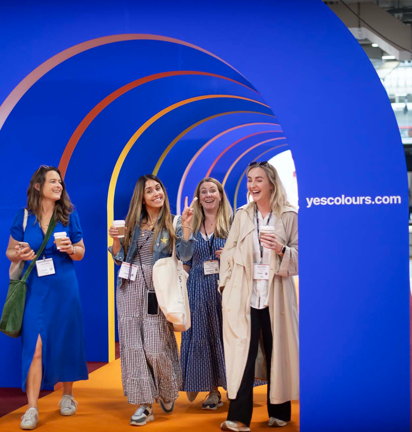 Group of women walking through YesColours archway in Electric Blue